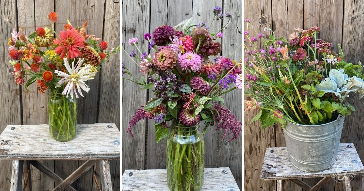Three vases of colorful flowers on wooden stools in front of a rustic wooden fence.