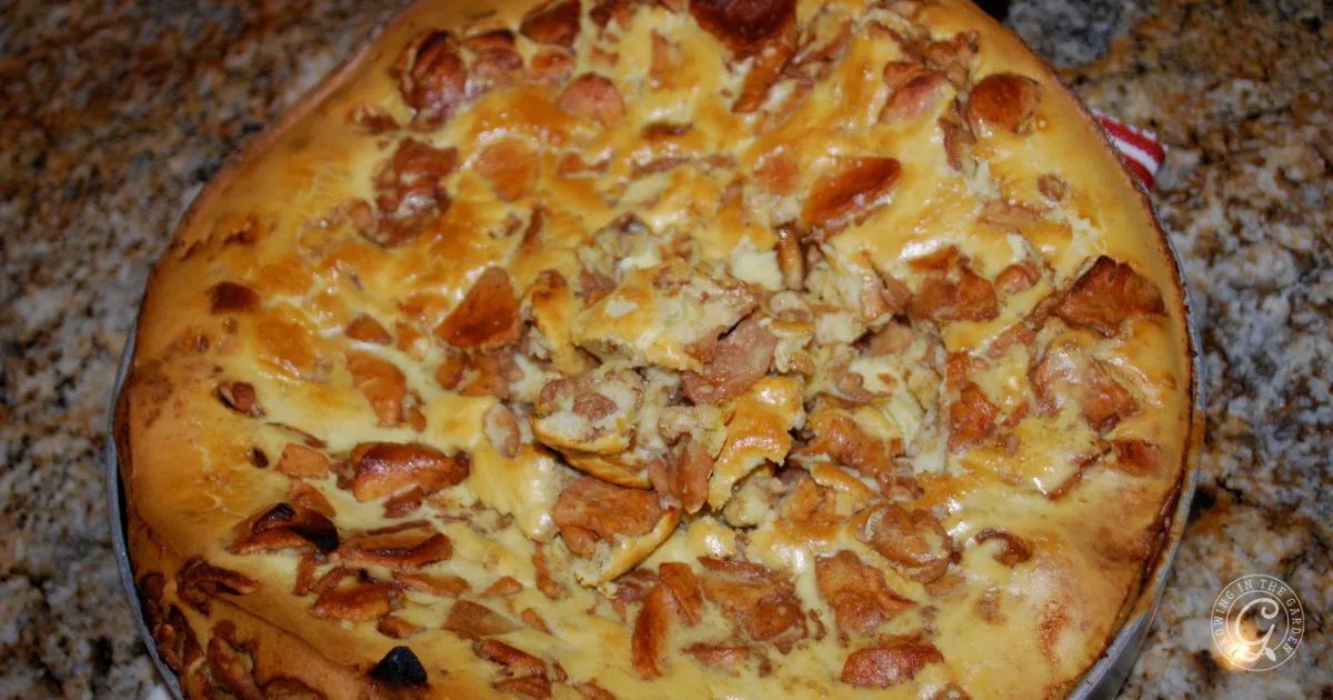 Golden brown baked pie with a creamy filling and pieces of what appears to be cooked mushrooms on top&mdash;perfect for pairing with the best recipes for Anna apples.
