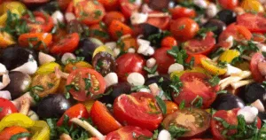 A colorful mix of sliced cherry tomatoes, herbs, and onions fills the frame&mdash;perfect inspiration if you&rsquo;re learning how to preserve basil or want tips on how to freeze basil for future recipes.