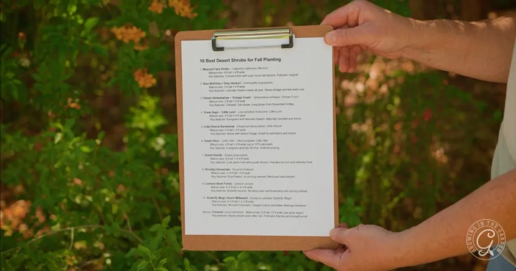 Person holding a clipboard with a printed plant list in a garden, surrounded by green leaves, possibly reviewing the best shrubs for desert landscape.