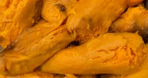 A close-up of several bright orange cooked sweet potatoes with soft, textured flesh—perfect for a make ahead sweet potato casserole or as the base for a delicious freezer sweet potato casserole.