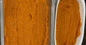 Bright orange sweet potato puree spread smoothly in metal and white baking dishes, ready for baking this delicious make ahead sweet potato casserole.