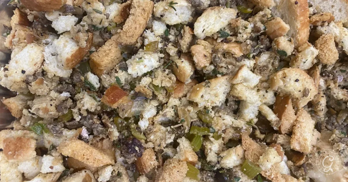 Close-up of homemade stuffing with bread cubes, celery, onions, and herbs mixed together.
