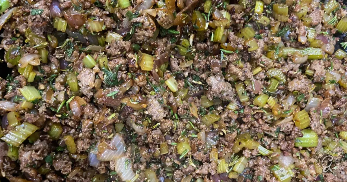 Cooked ground meat mixed with chopped celery, onions, and herbs.