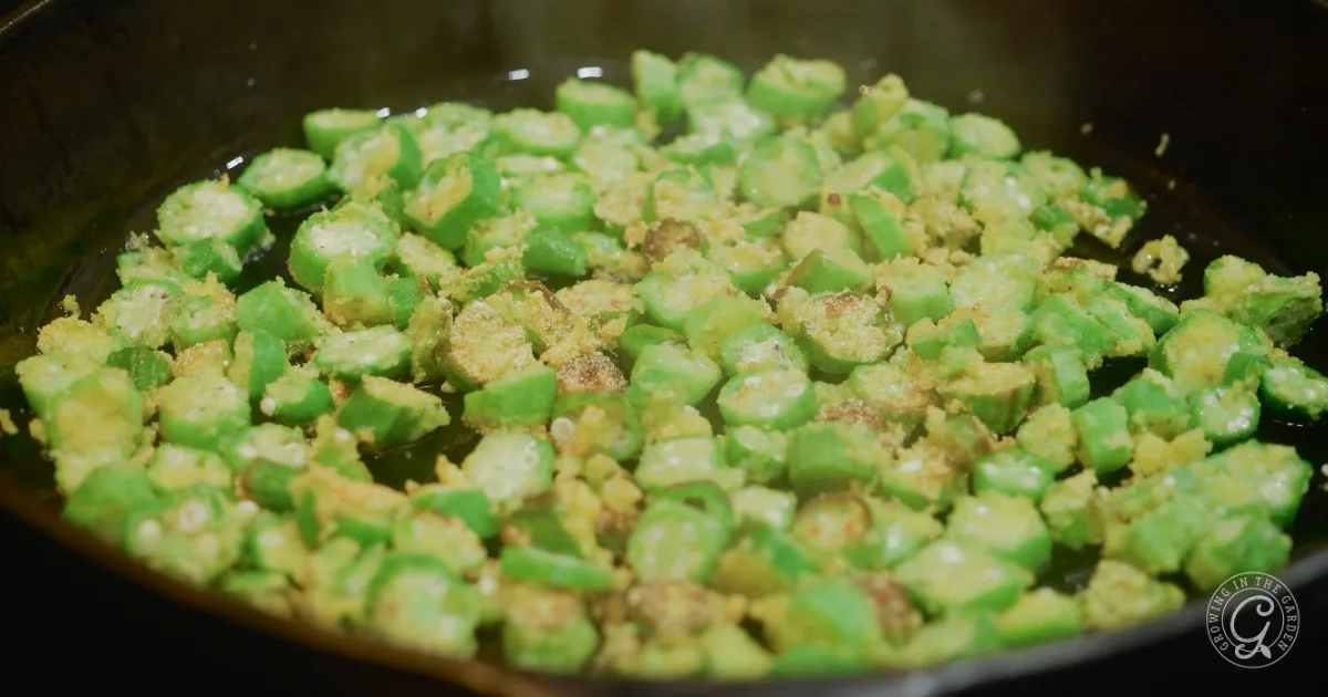 Easy Southern Comfort Food: Chopped okra frying in a pan with batter coating, starting to turn golden brown&mdash;classic Fried Okra at its best.